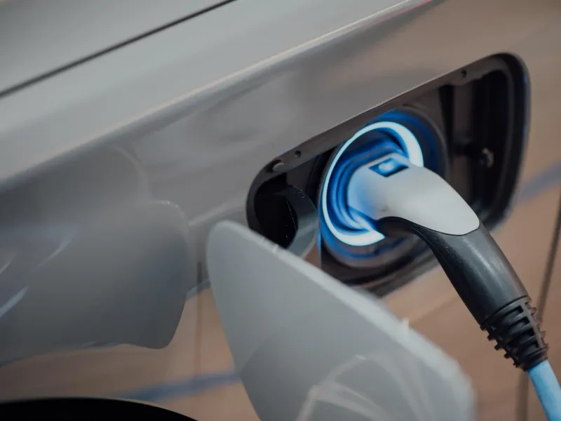 A charging cable plugged into an electric vehicle