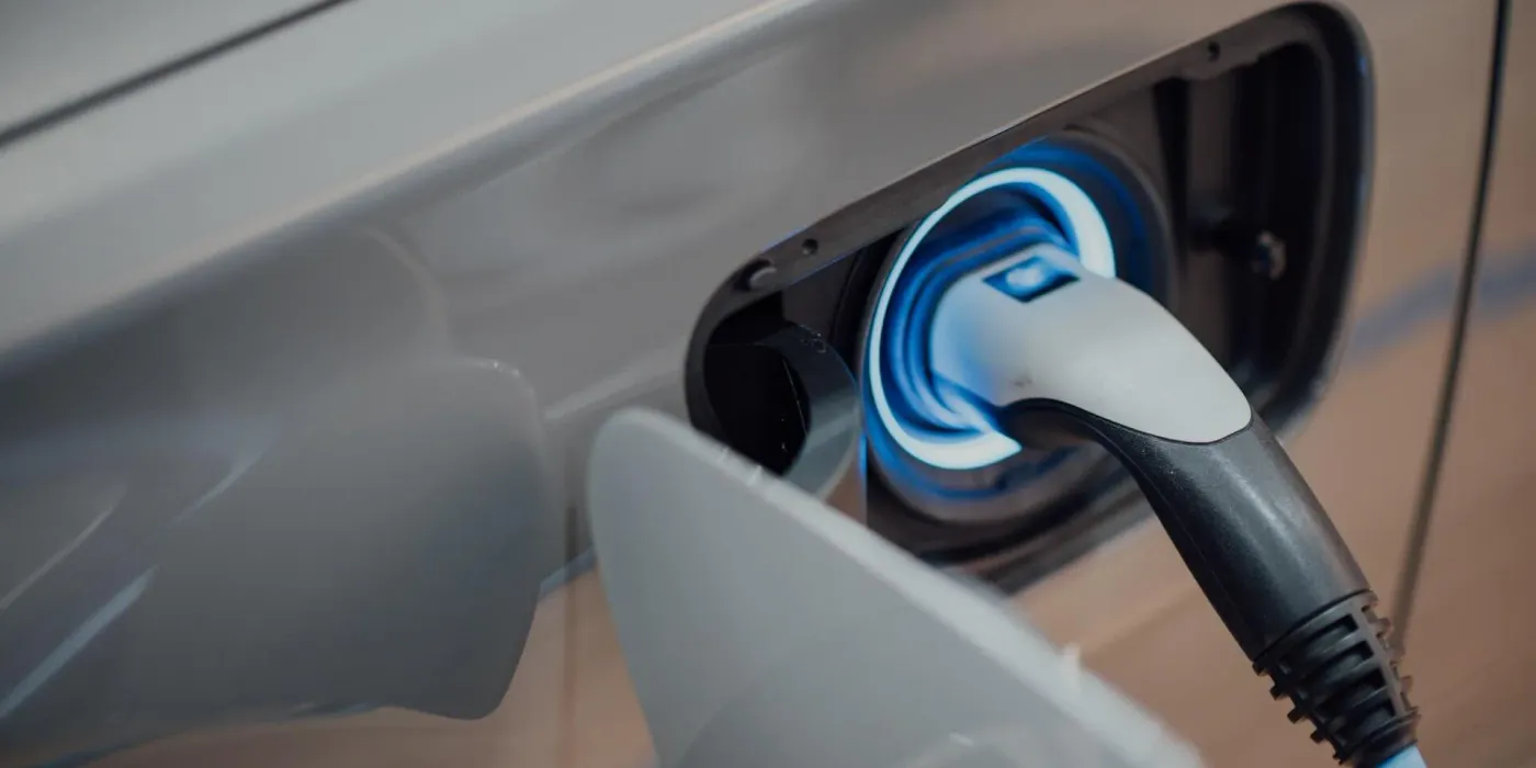 A charging cable plugged into an electric vehicle